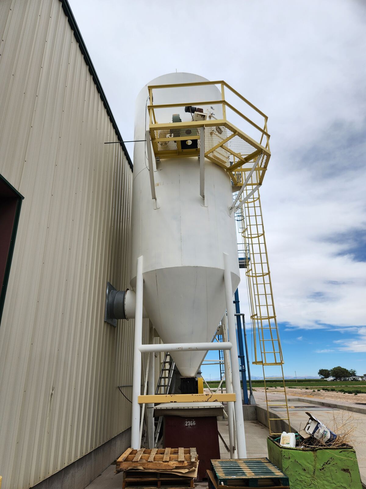 The dust collector tank before recoating, with faded, failing paint at a Northern Utah facility