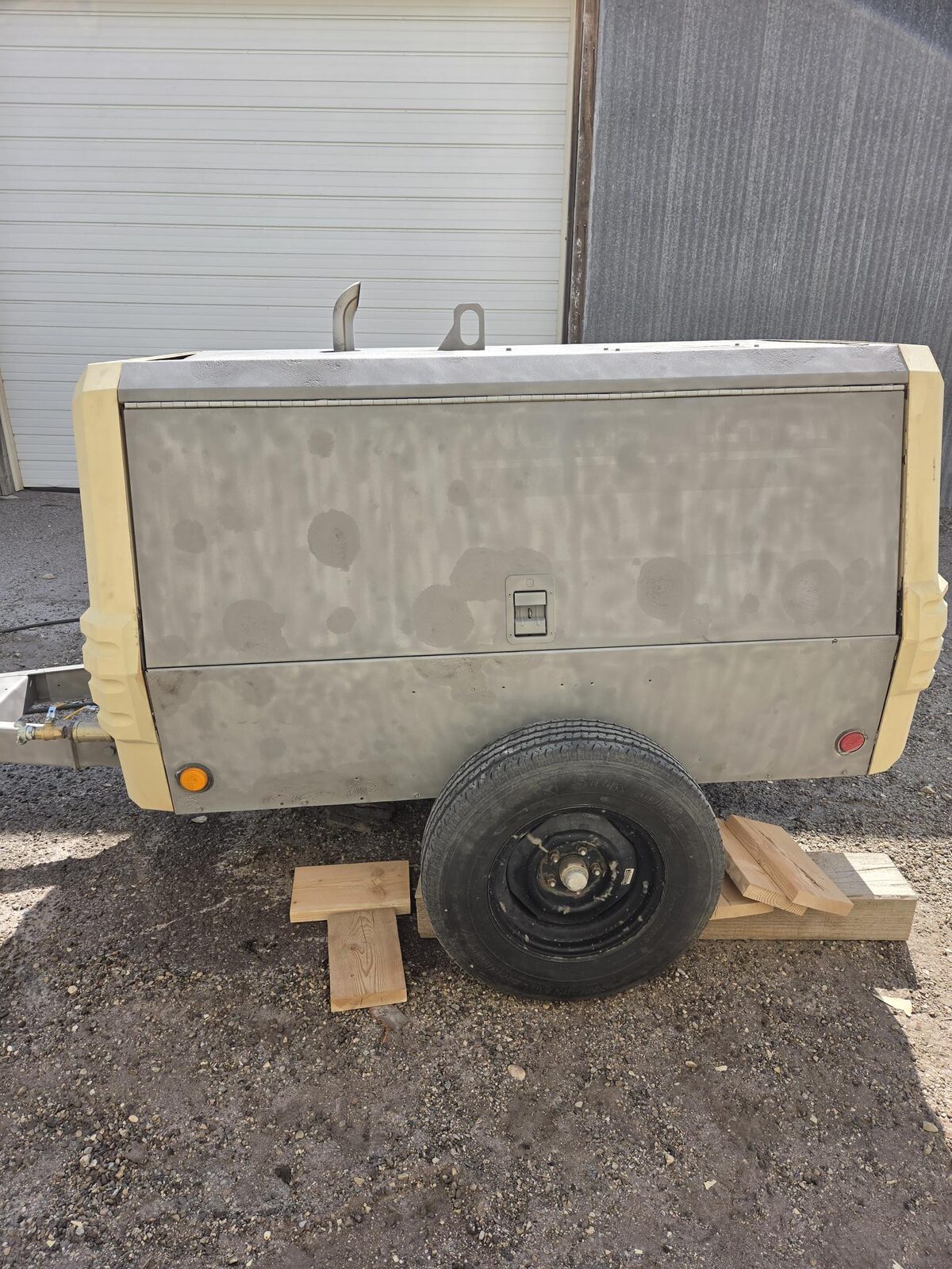 Rear view of the sandblasted Ingersoll Rand 185 compressor, prepped and ready for paint