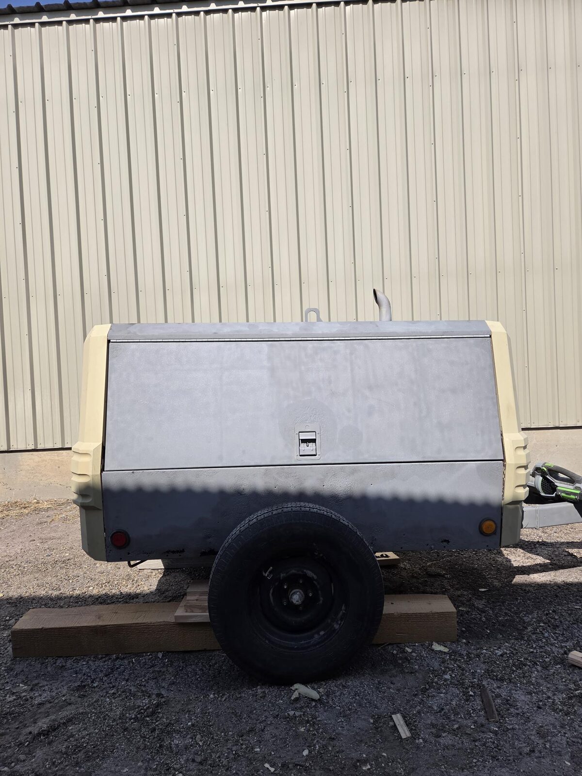 Side view of the Ingersoll Rand 185 compressor sandblasted to clean bare metal