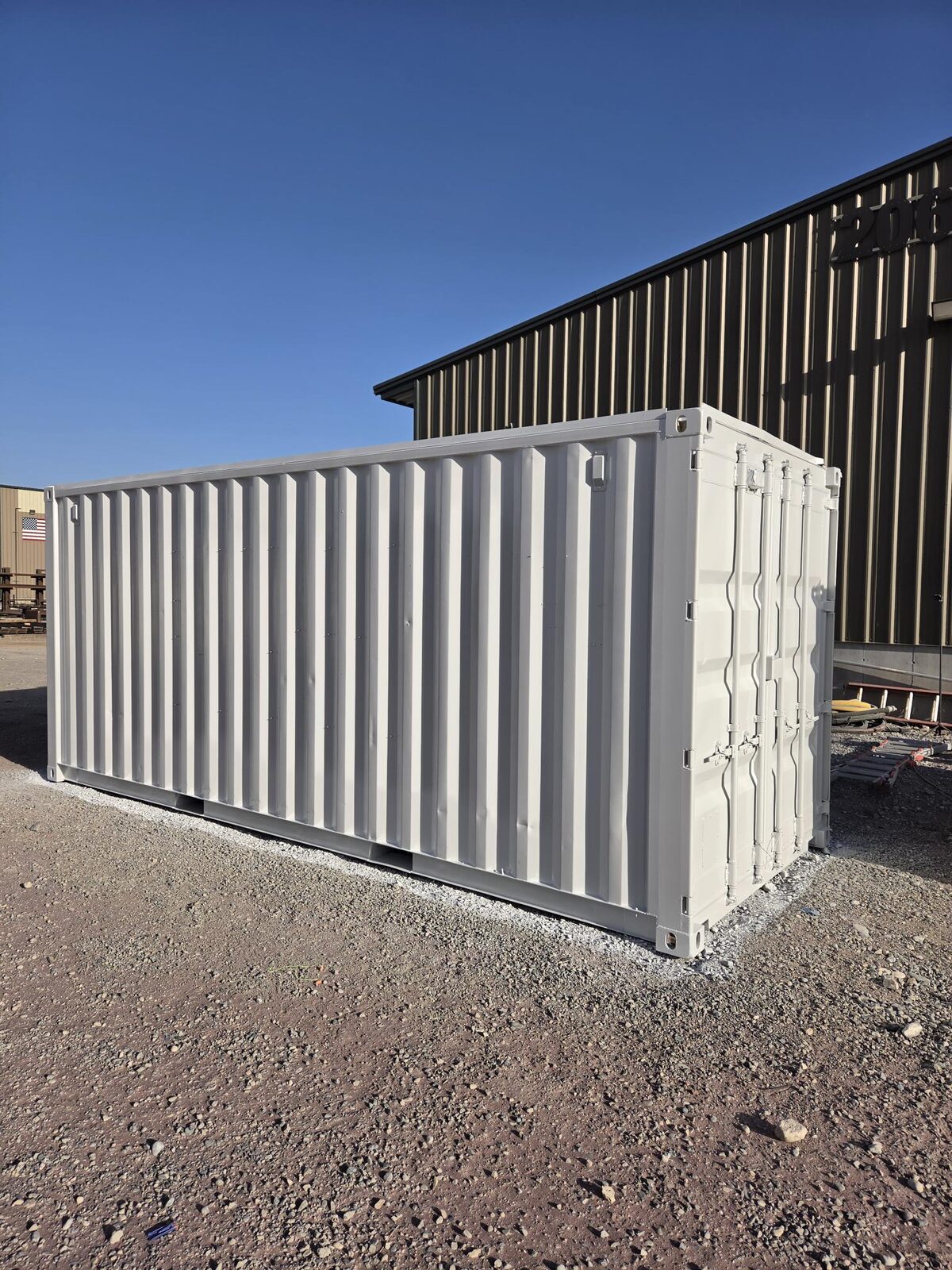The shipping container sealed in gray industrial epoxy primer after sandblasting